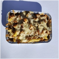 Met gefrituurde kip. Geserveerd met knoflook, sambal en rauwkost